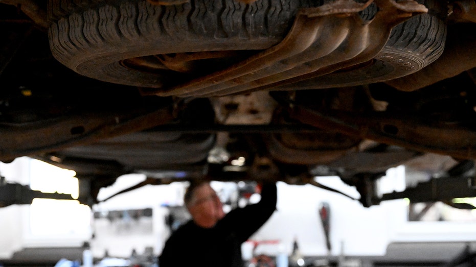 Mechanic underneath a vehicle working