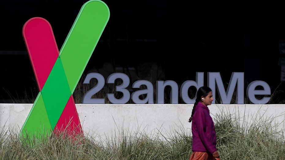 23andMe sign with a person walking past