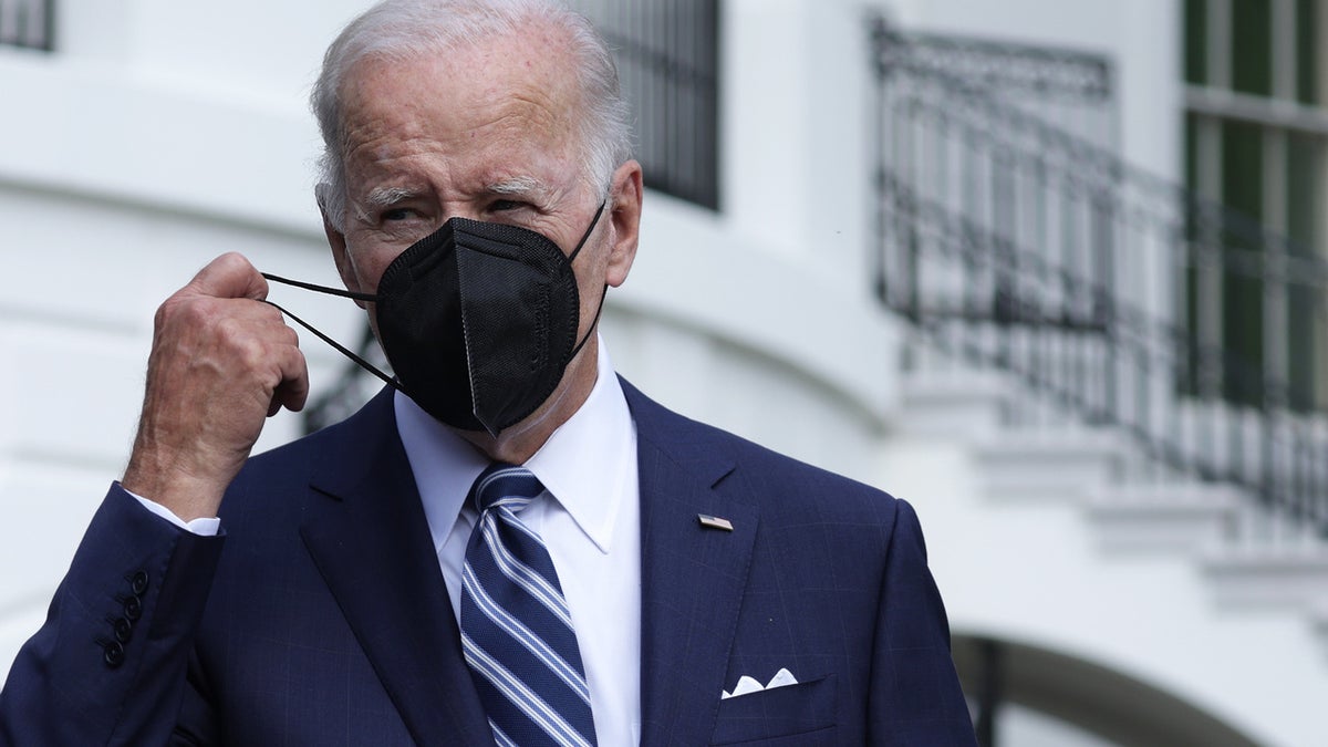 President Joe Biden takes off his mask