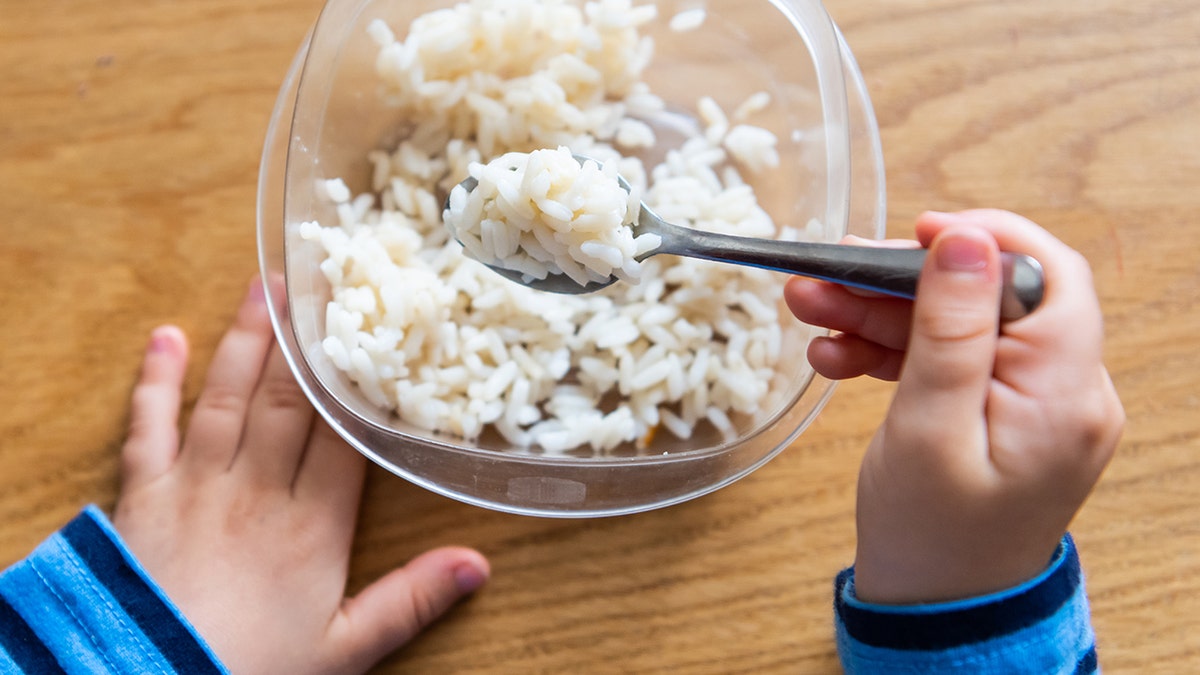 Child eating white rice