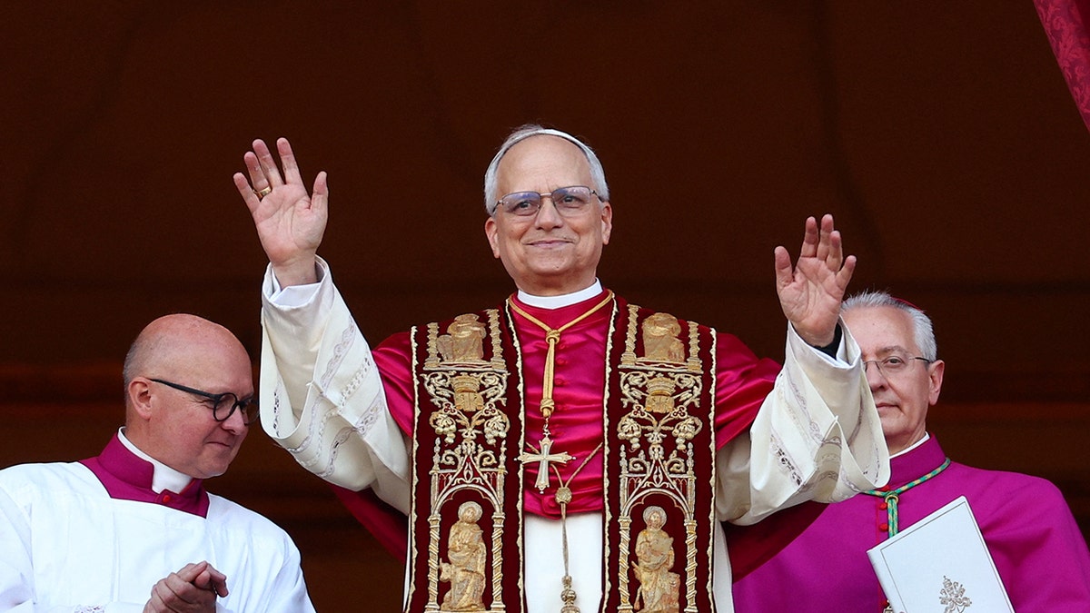 New American Pope Leo XIV greets crowd with his hands up at the Vatican